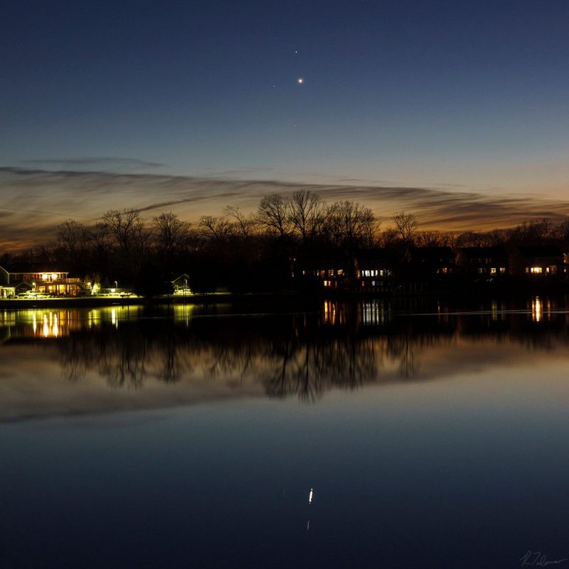 Venus and Saturn, in evening twilight, reflected in a lake.
