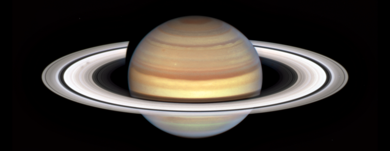 Bright white ring system around a golden sphere.