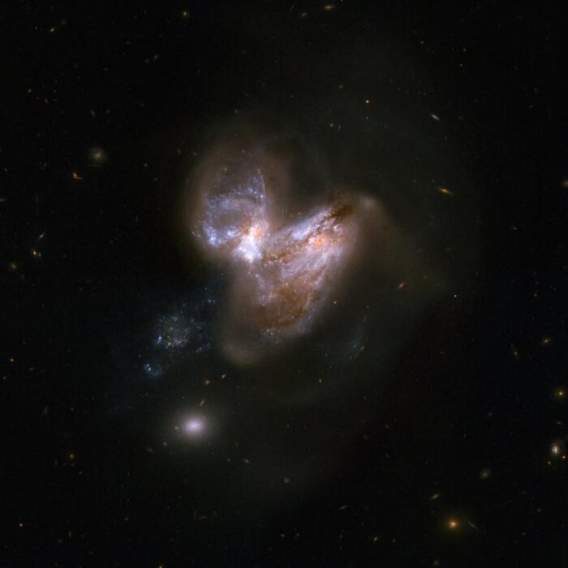 Supermassive black hole: Dark sky with 2 irregularly shaped galaxies mashed up together.