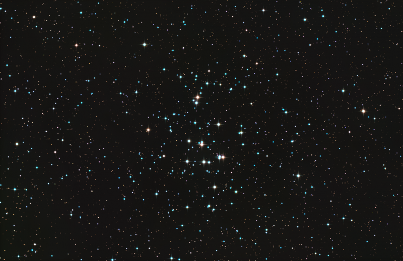 Star field with a loose cluster of stars at center.