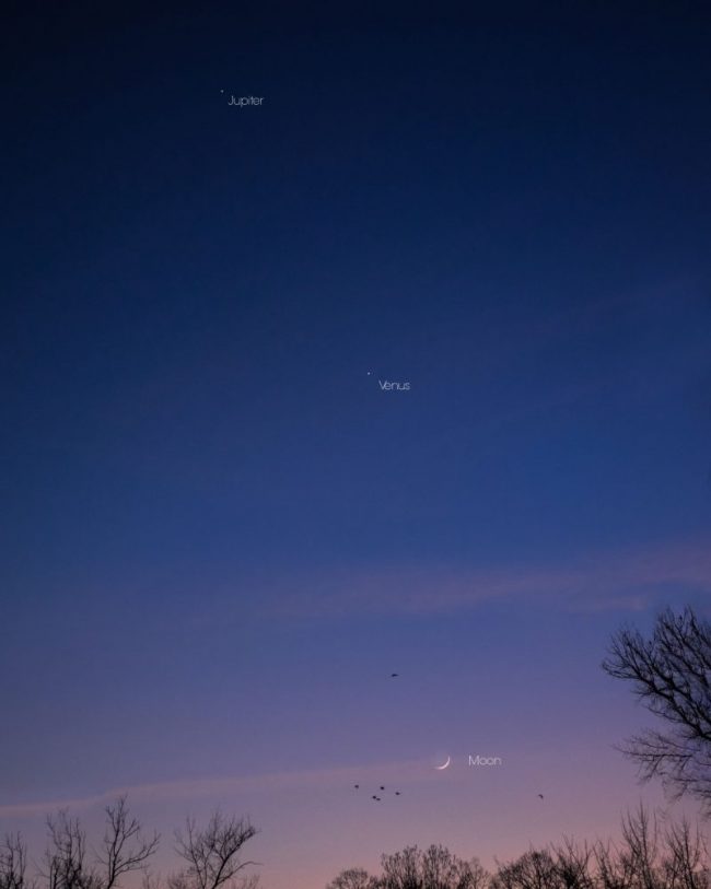 Sky fading from pink to dark blue with 2 tiny bright points at top and bottom. Crescent moon near horizon.