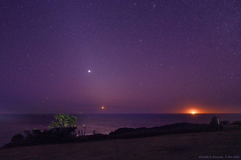 Orange glow on horizon at right with 2 bright dots, 1 near horizon and 1 upper left.
