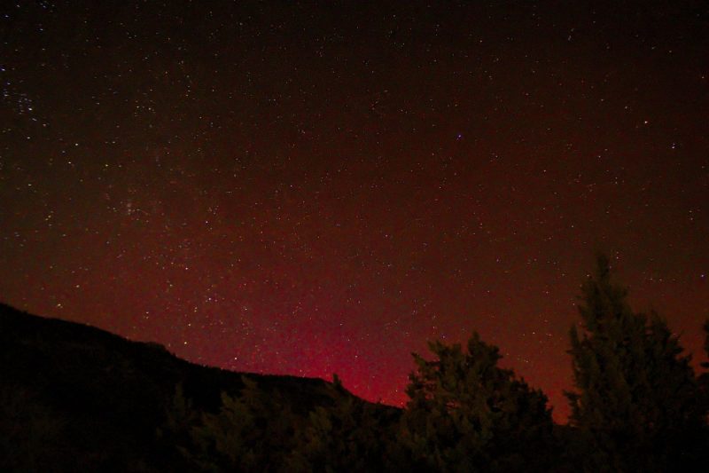 A red glow along the darkened horizon.