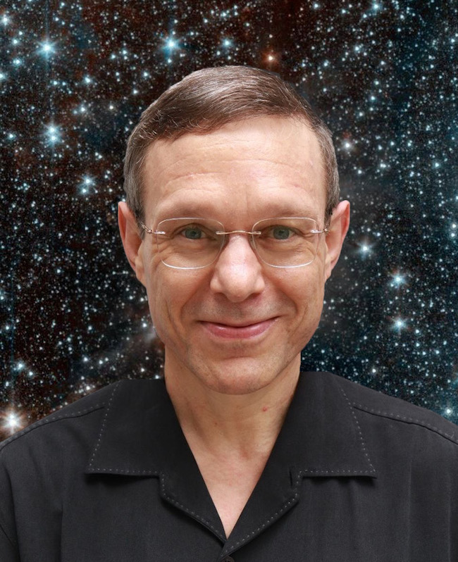 Man with a V-neck button shirt and wire rimmed glasses smiling with mouth shut and background of stars.