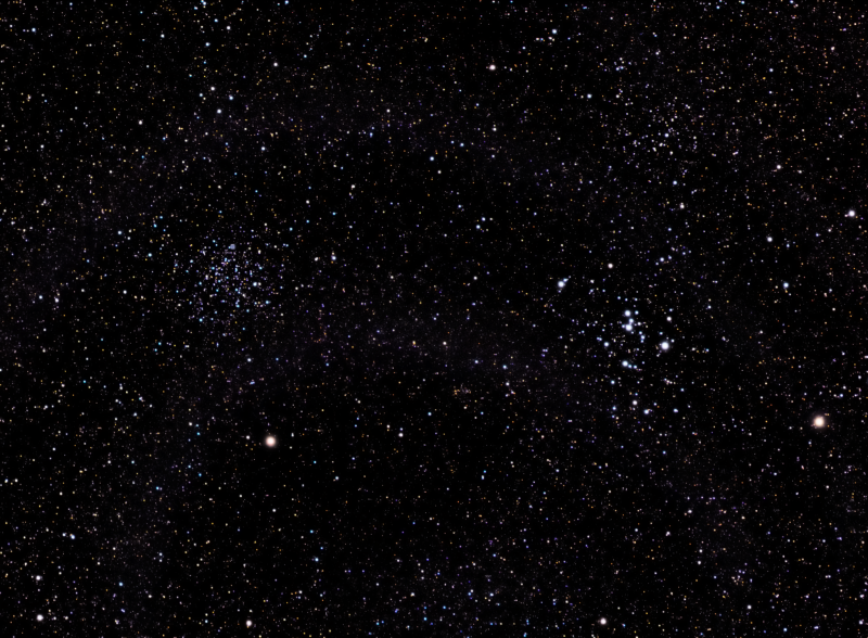 Two groupings of stars, one large and one small, with a multitude of background stars.