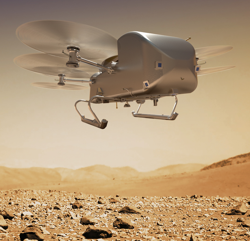 Lake on Titan: Drone-like machine with six rotors flying over reddish rocky terrain.