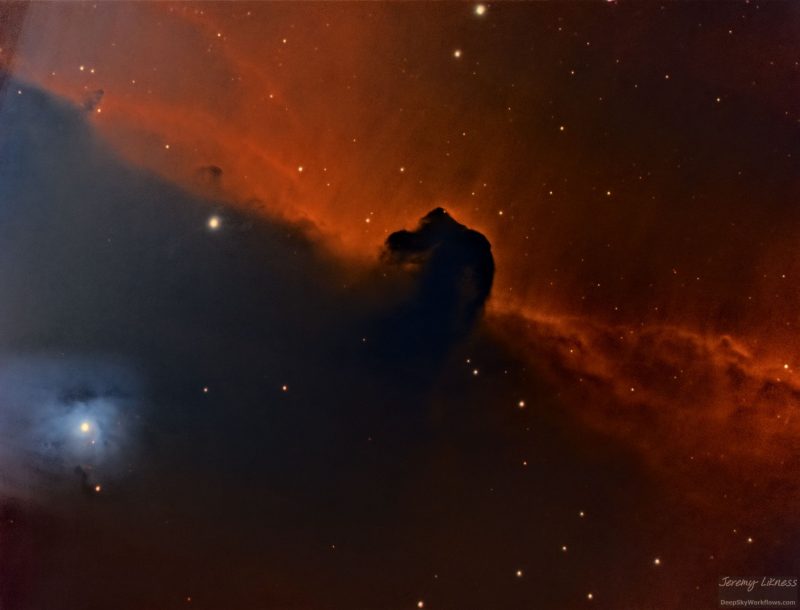 Large, red cloud of gas with a horse-shaped indentation and a dozen background stars.