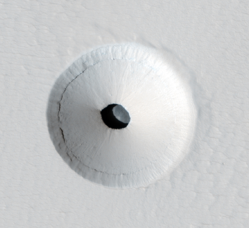 Exploring Martian caves: Crater seen from above with deep round hole in its center.