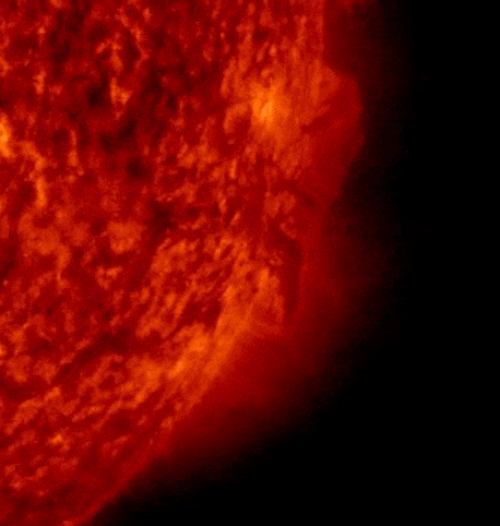 April 28, 2023, sun activity: A giant prominence with an arc shape comes out of a red sphere and breaks in half.