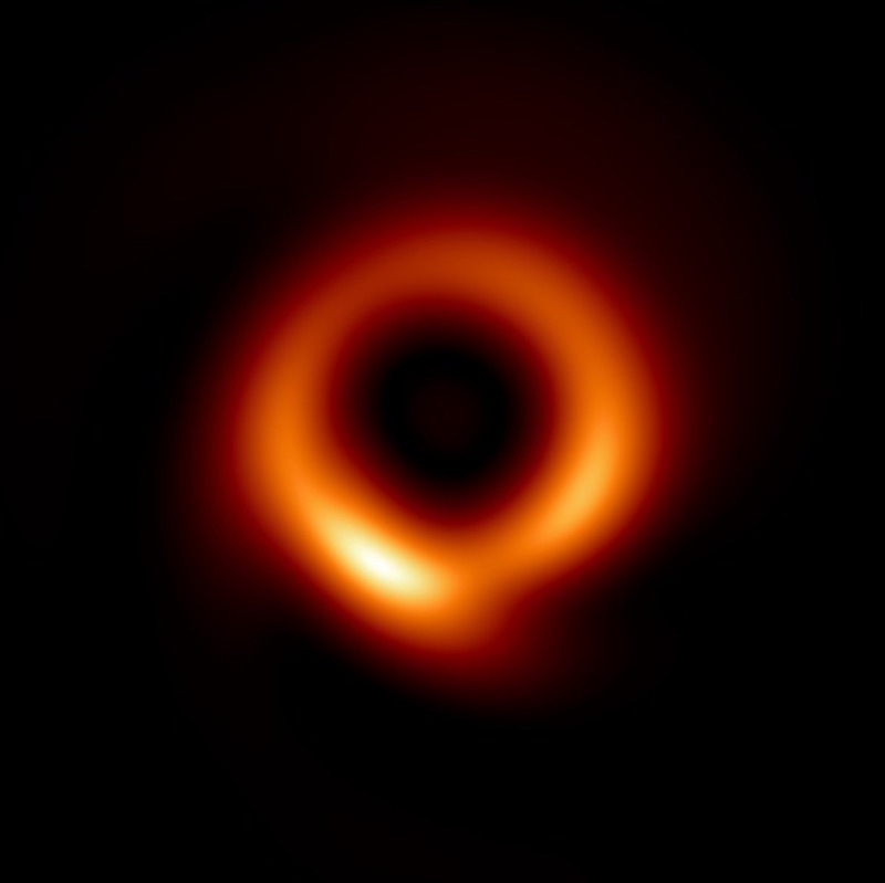 A glowing red, orange, and yellow shape ring, with a large black center, on black background.