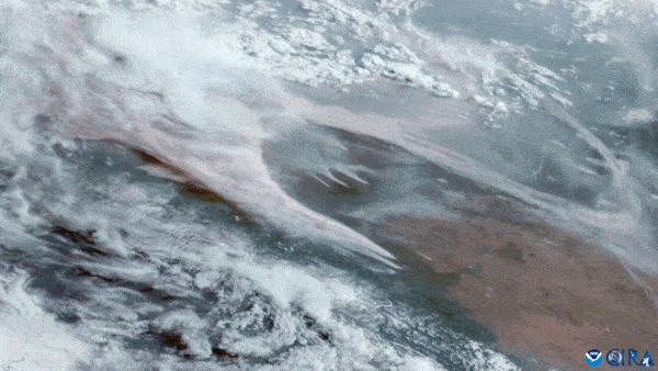 Alberta wildfires: Flares with smoke billowing and clouds nearby.