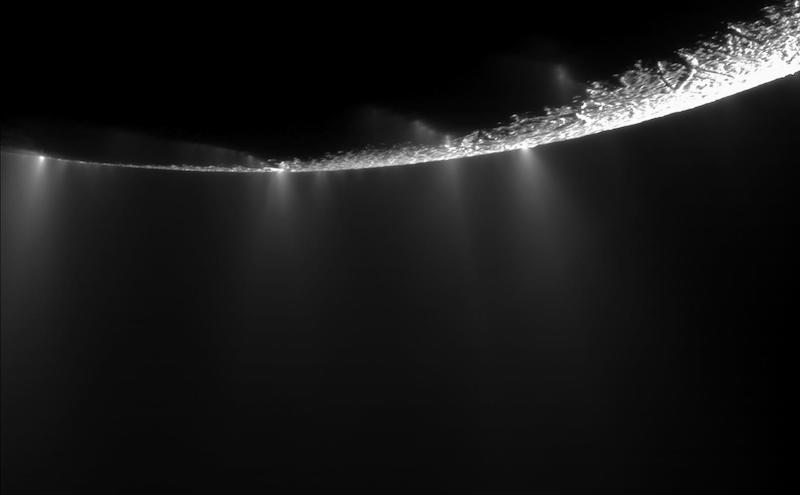 Enceladus: Sunlit limb of moon-like body with plume-like jets coming off it.