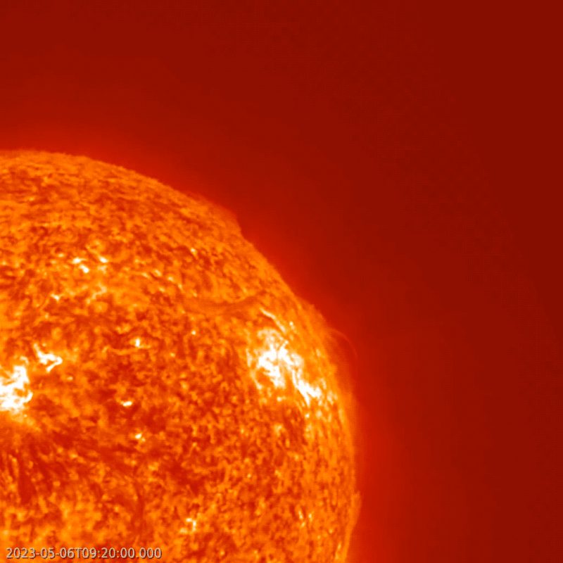 Right upper quarter of an orange globe. Animated showing material lifting off the sun.