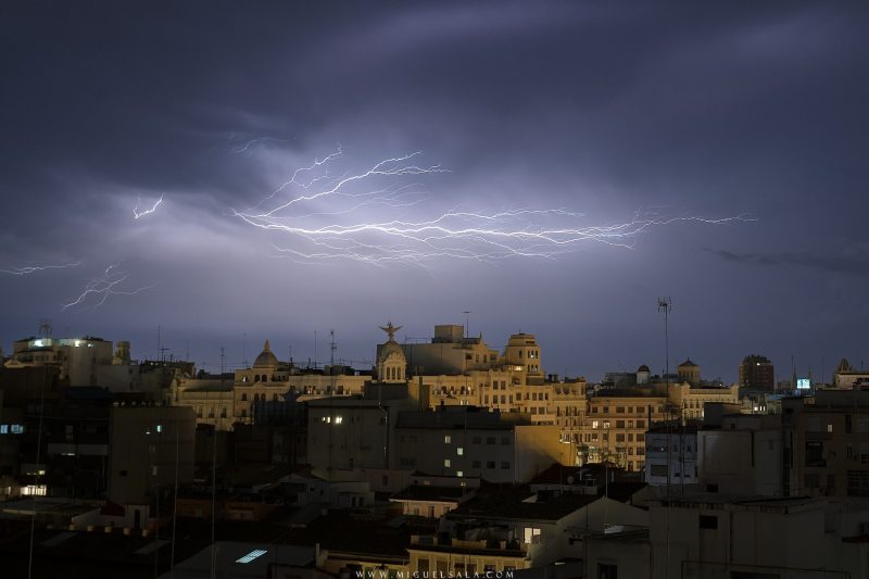Astraphobia: Old buildings of Valencia below lightning streak out across the sky.