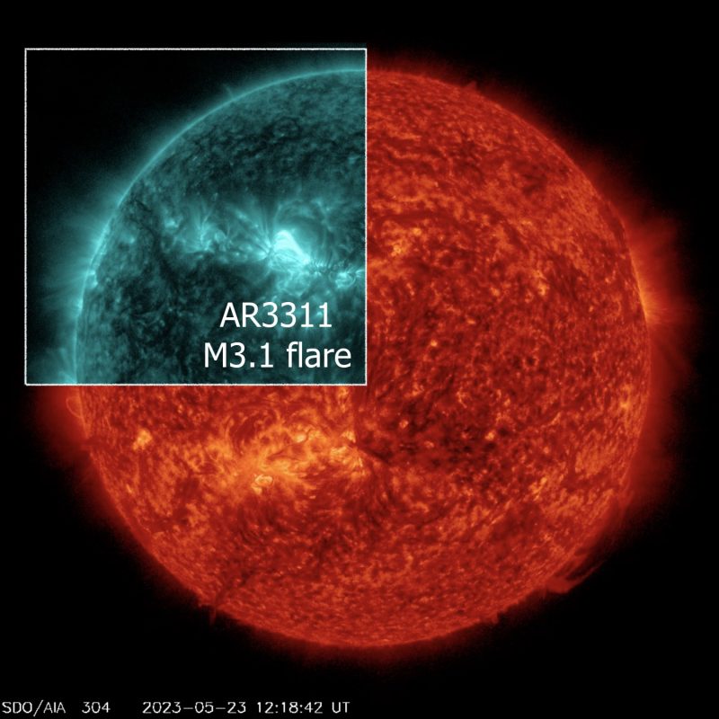 May 23, 2023 A red sun with a teal insert showing bright flaring areas.