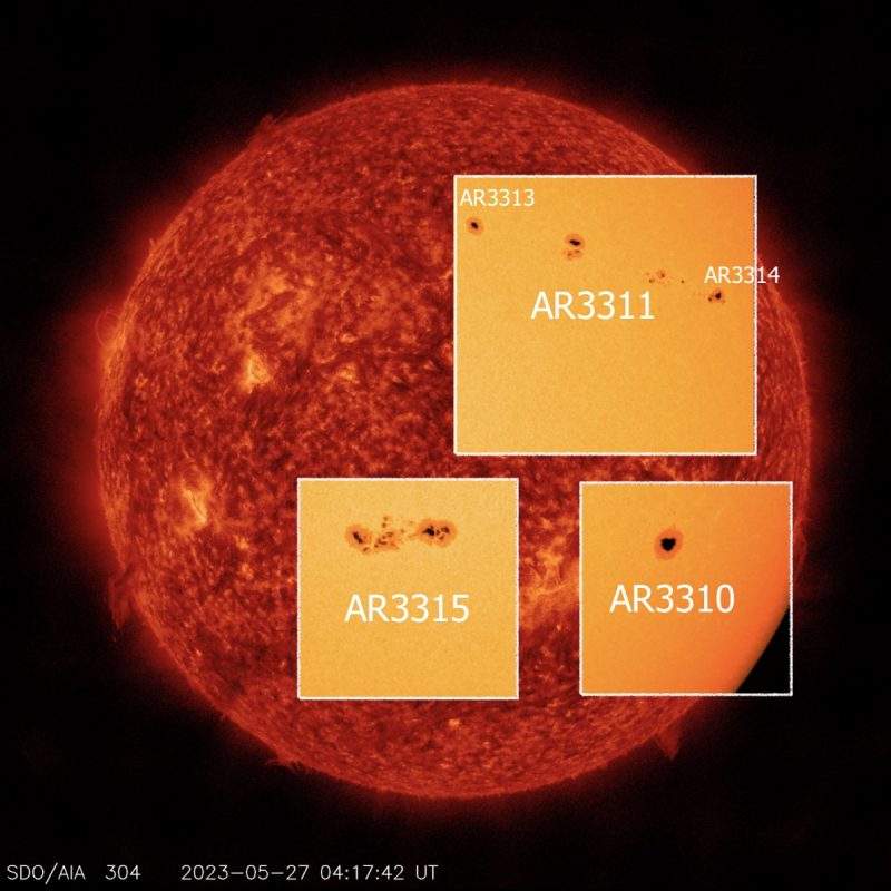 A red sun with three yellow blocks showing sunspots.