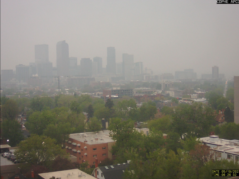A photo looking out at the Denver skyline shows a very hazy city.