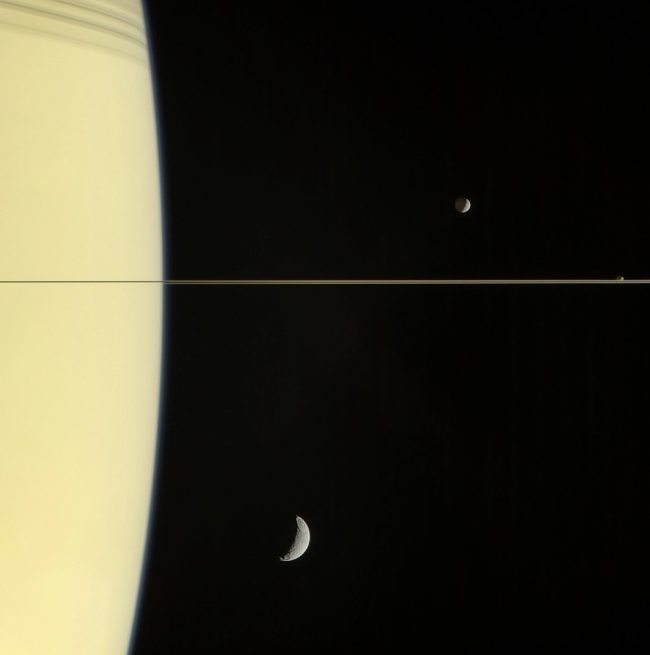 Saturn's moon: Closeup on limb and thin ring of Saturn with some crescent moons.