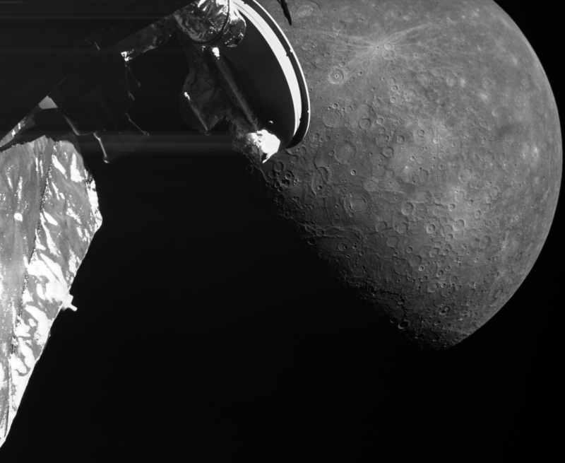 Black and white image of a spacecraft arm with a cratered world behind it.