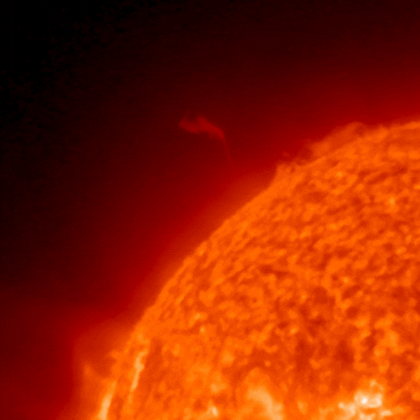 A quarter of a red circle shows a prominence on the sun.