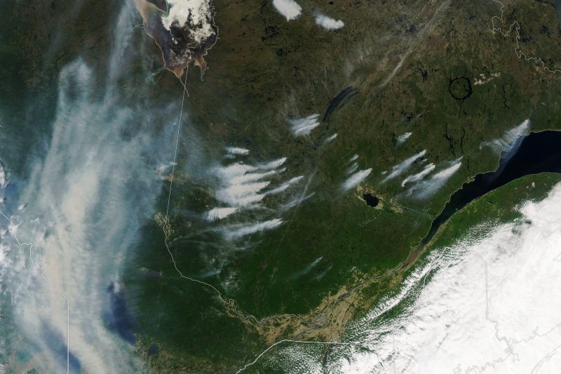 Canadian wildfire smoke: Satellite view of Quebec, Canada, with streaks of white showing smoke streaming from fires.