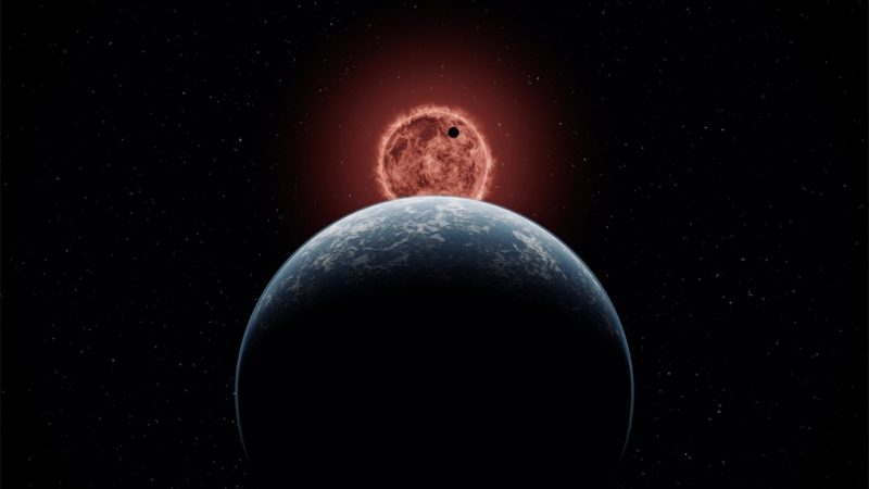 Definition of planet: Blue planet seen from behind, with a small dark planet facing the red sun in the distance.