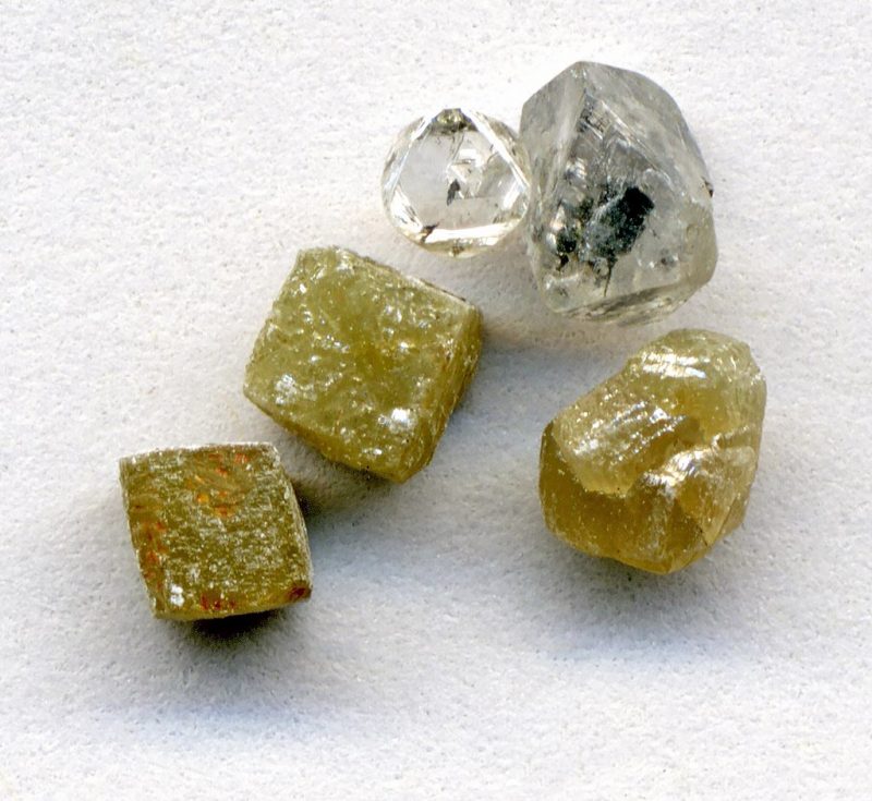Three yellowish-gray cubic diamonds and 2 clearish octahedral diamonds