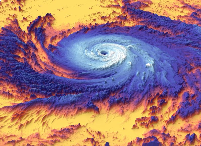 Hurricanes heat the ocean: Large, flat blue spiral swirl with white center, on background of yellow and orange.