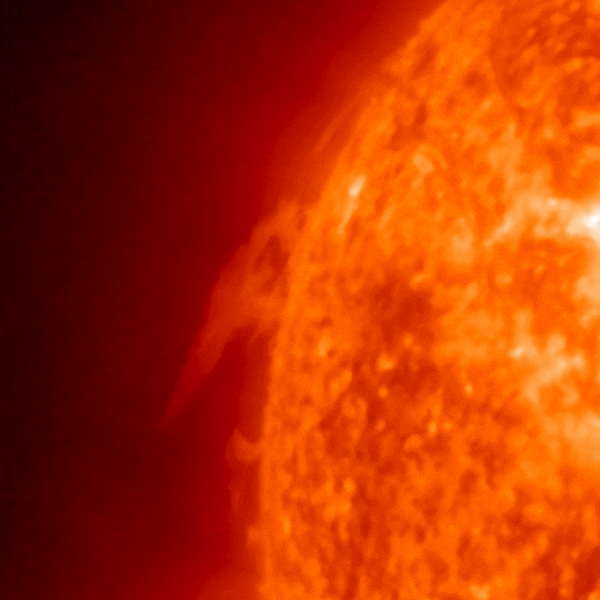 A quarter of a red circle with a dark background shows sun explosions.