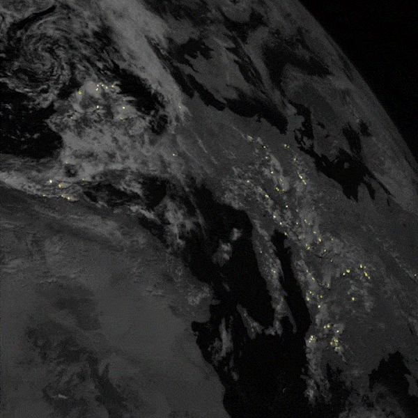 Lightning from space: Moving satellite image showing dark view of clouds with bright sparkling lights.