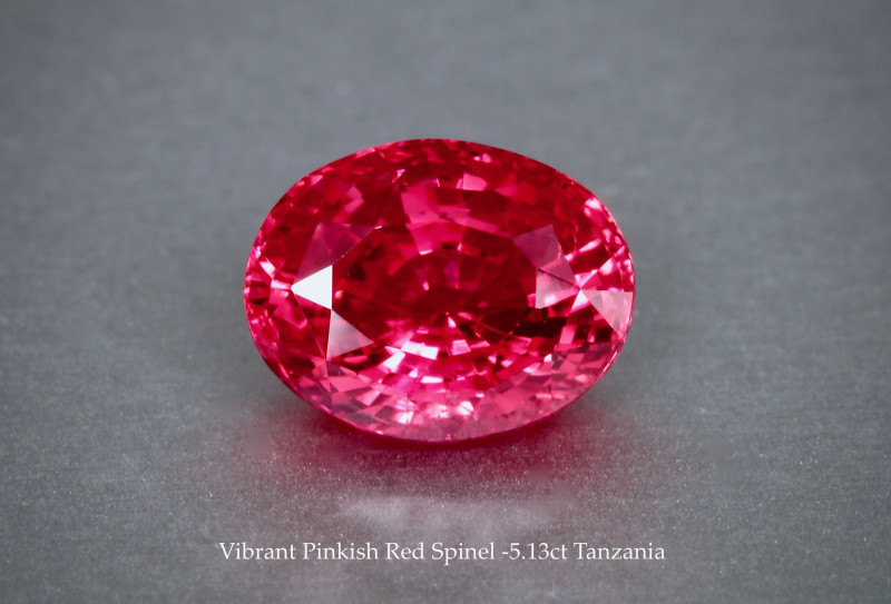 Facested reddish-pink gemstone.