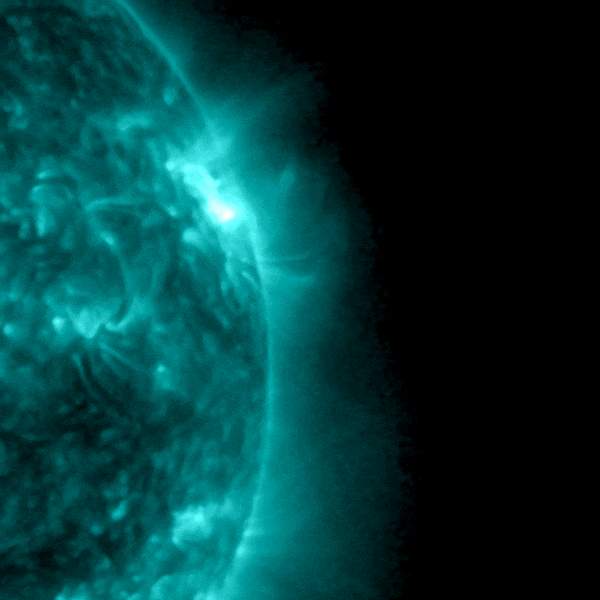 Closeup of roiling sun with sudden blast coming out of one side.