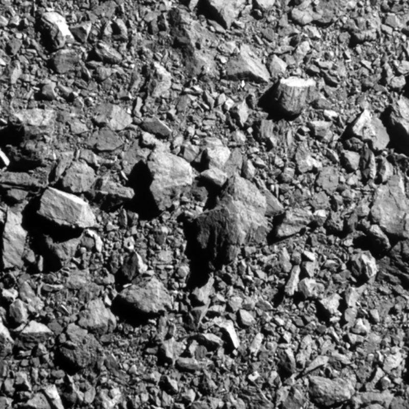 A gray rocky surface made of rocks of all sizes filling the frame.
