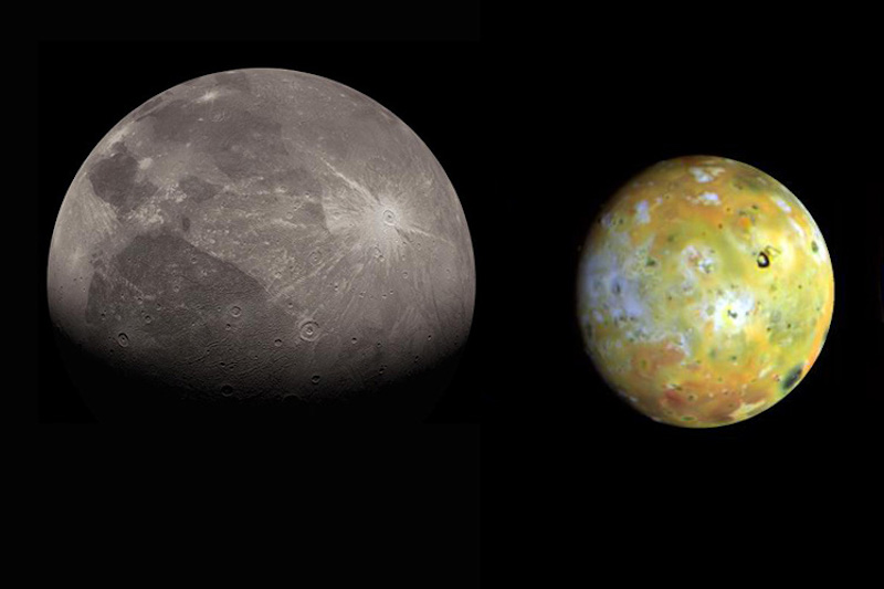 Gray moon-like body with dark blotches and bright multi-colored and spotty sphere, on black background.