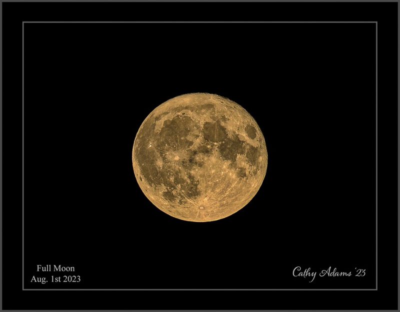 Framed image of large, bright full moon.