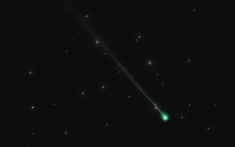 Photos of Comet Nishimura: Dark sky with a few stars, small fuzzy green orb and a long, thin, faint greenish tail.