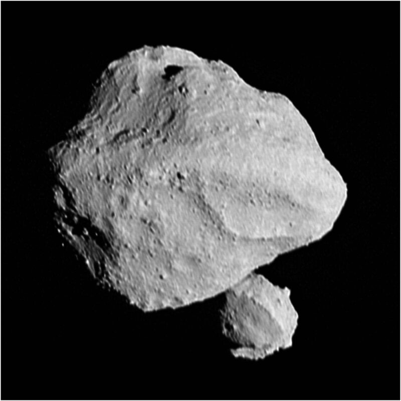 Lucy spacecraft: Large, lumpy gray rock in black sky plus a smaller lumpy rock partly behind it on the lower right.