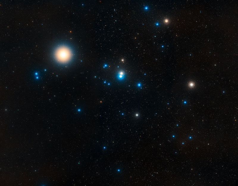 Dozens of different sized and colored (mostly blue) stars in space.