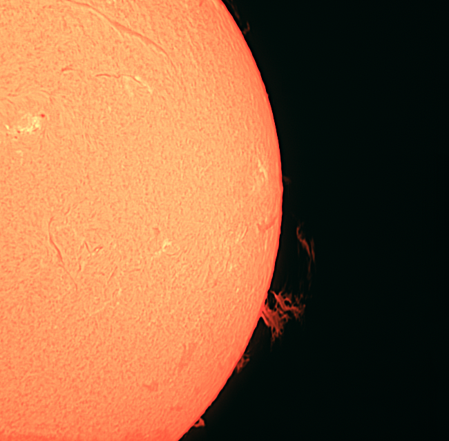 The sun, seen as a sectional orange sphere with a mottled surface.
