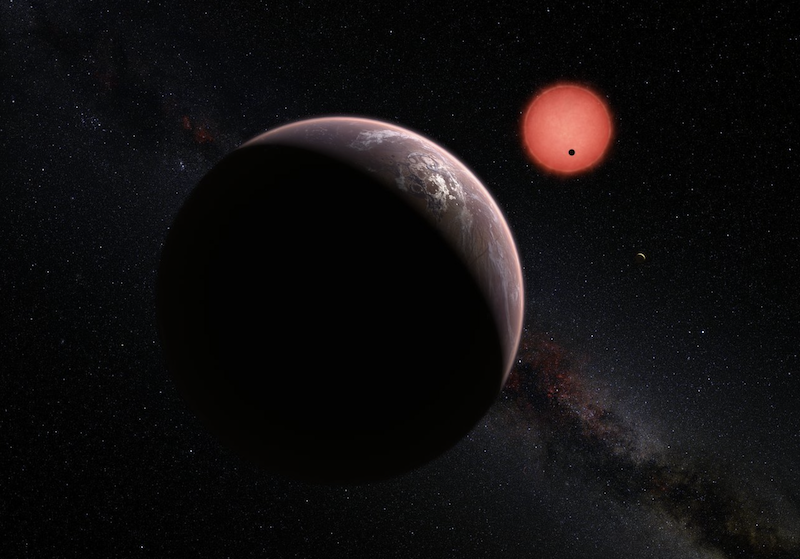 TRAPPIST-1e: Rocky planet with clouds and distant small, red sun, with 2 other planets tiny with distance.