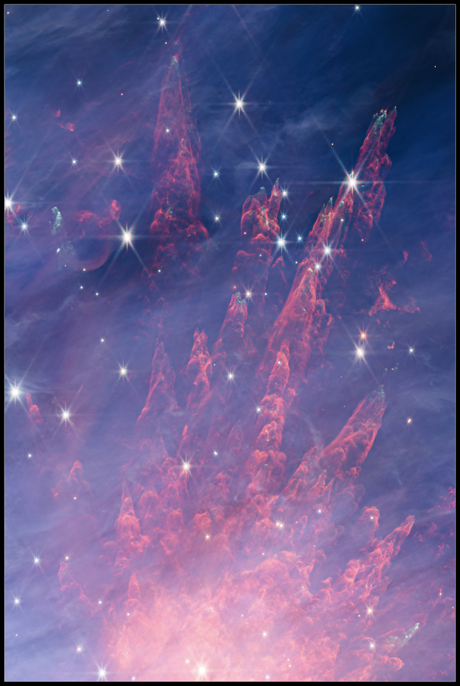 Long pink cloud-like tendrils in dark blue space, with many bright stars scattered around.