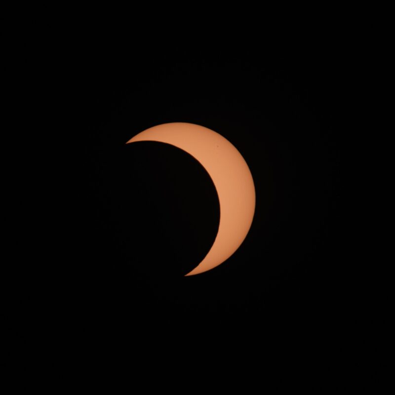 A crescent orange shape with black everywhere else.