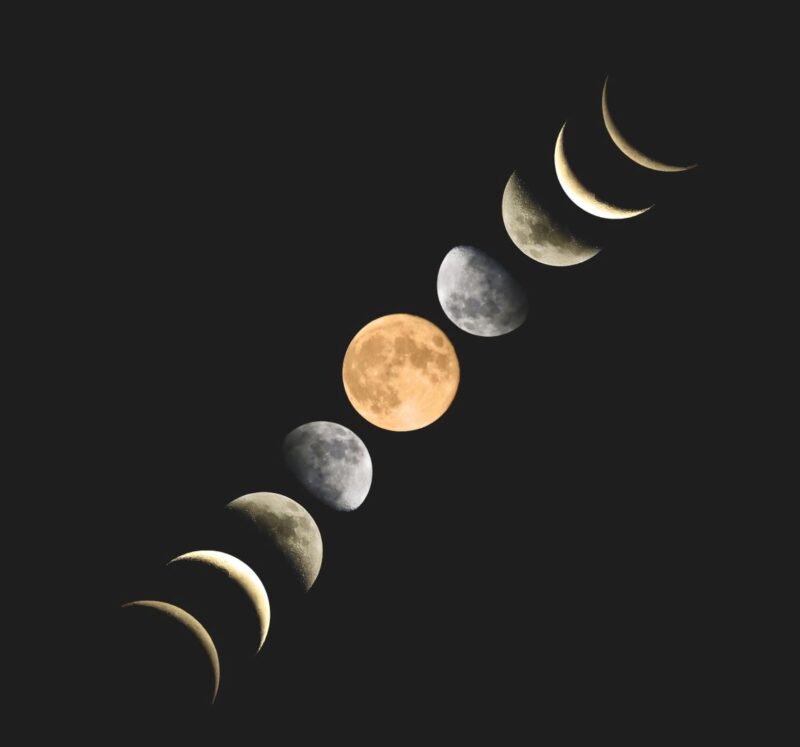 Phases of the moon, from new to full to new again lined up in a diagonal row. The full moon is orange. The rest are grey.