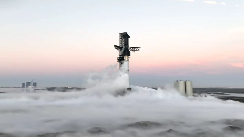 Blue band topped with pink band on the horizon with rocket on the launchpad and billowing steam fog near the ground.