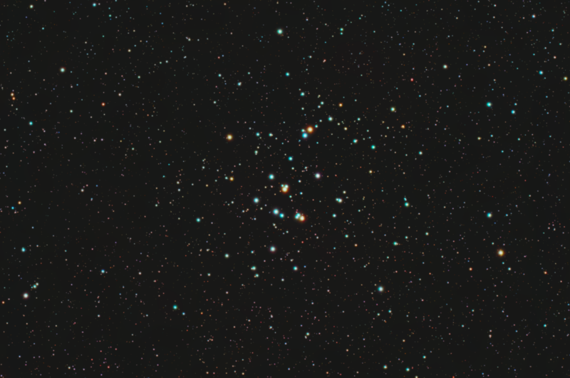 A large, sparse grouping of a few dozen bright stars with a multitude of background stars.