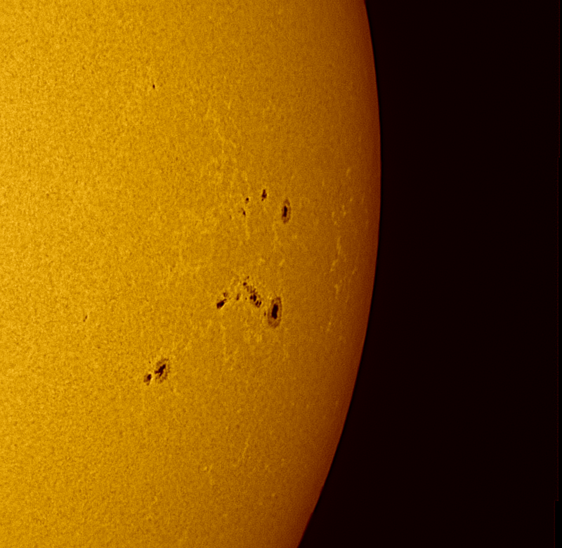 A sectional yellow sphere representing the sun, with large dark spots.