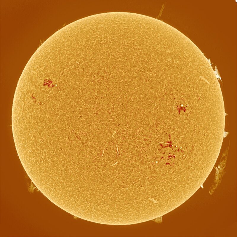 The sun, seen as a large yellow sphere with a mottled surface.