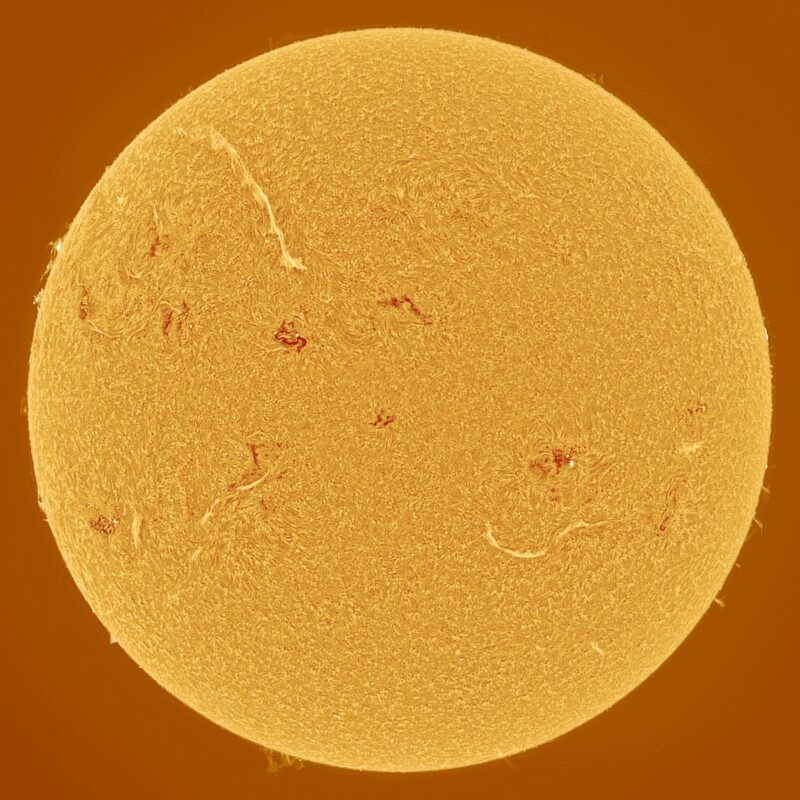 The sun, seen as a large yellow sphere with a mottled surface.