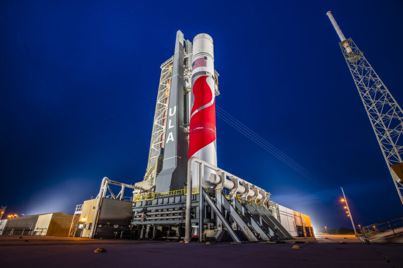 First commercial lunar lander: Red-and-white rocket at launchpad at night.