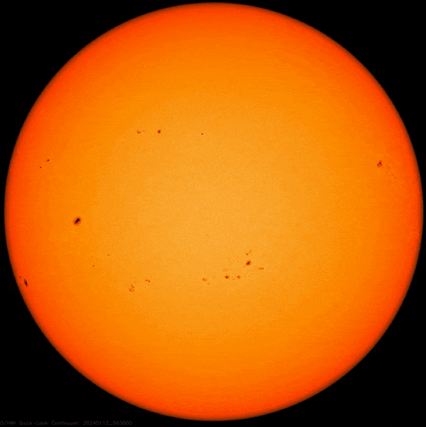 An orange circle showing the sun with dark spots.